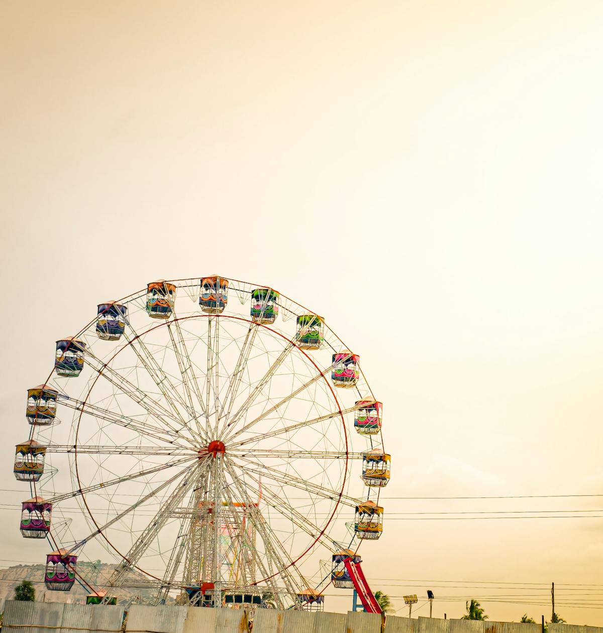 Colorful Ferris wheel at sunset in an amusement park